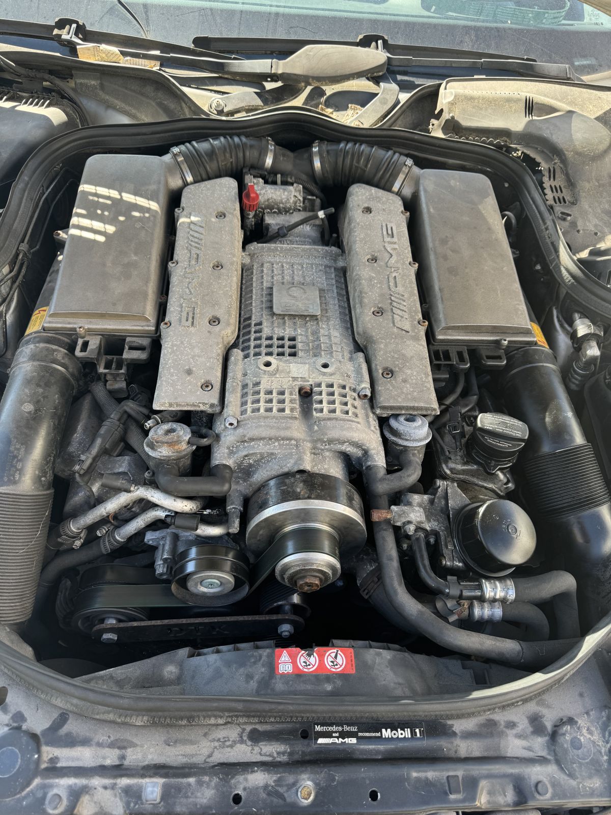 Mercedes-Benz AMG M113K supercharged V8 engine bay with AMG intake covers and supercharger visible at TOP CONCEPT Philadelphia