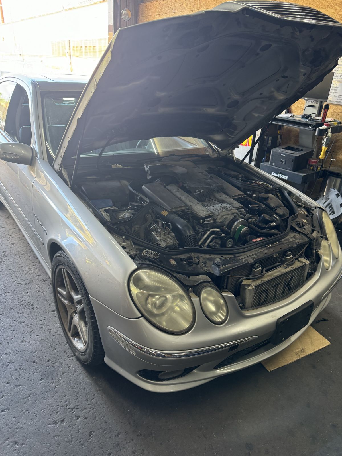 Silver Mercedes-Benz E-Class AMG with hood open in service bay at TOP CONCEPT Philadelphia