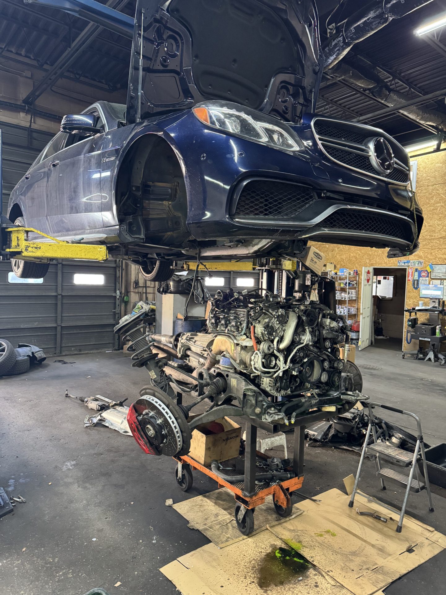 Mercedes-Benz E63 AMG W212 raised on lift with V8 biturbo engine and transmission removed at TOP CONCEPT Philadelphia