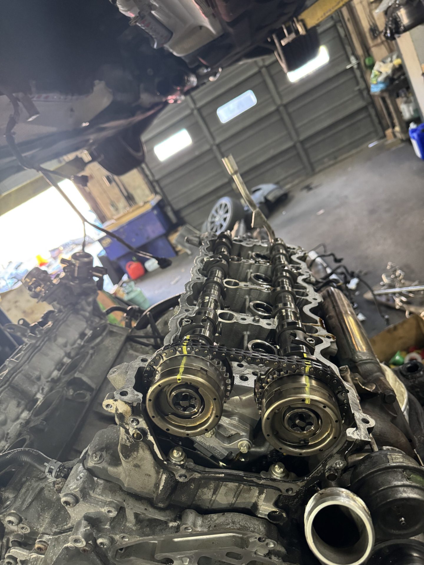Exposed camshafts and timing chain on Mercedes-AMG V8 engine during cylinder head service at Philadelphia repair shop