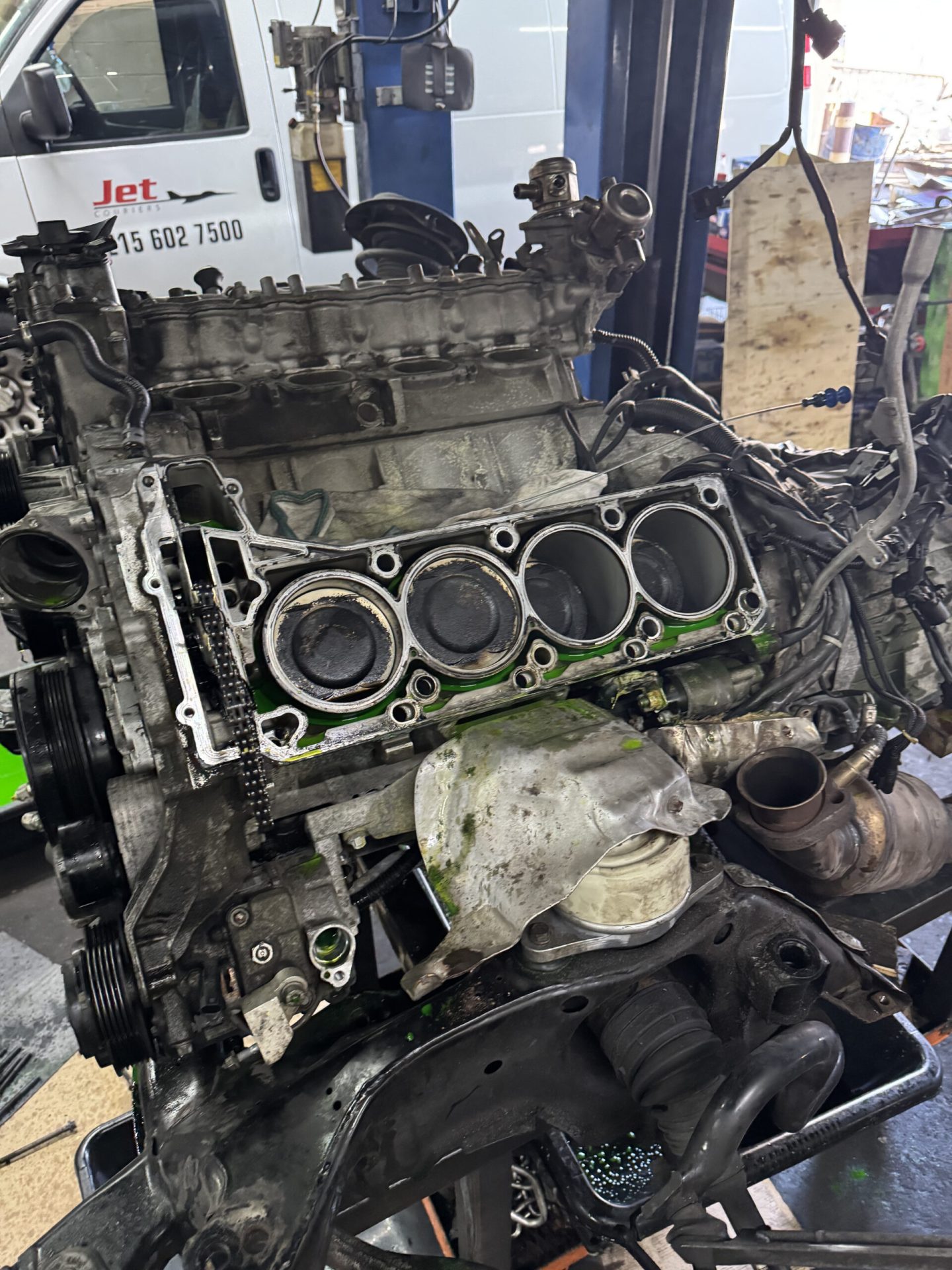Mercedes-Benz E63 AMG V8 engine block with cylinder head removed showing four cylinder bores during engine rebuild in Philadelphia
