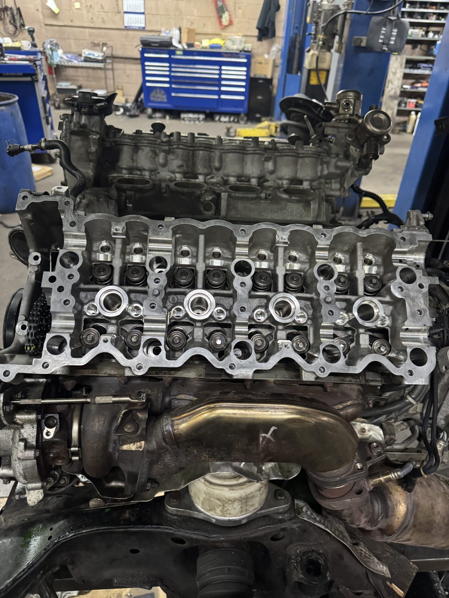 Mercedes-AMG V8 cylinder head removed showing valve train components during engine rebuild at TOP CONCEPT Philadelphia