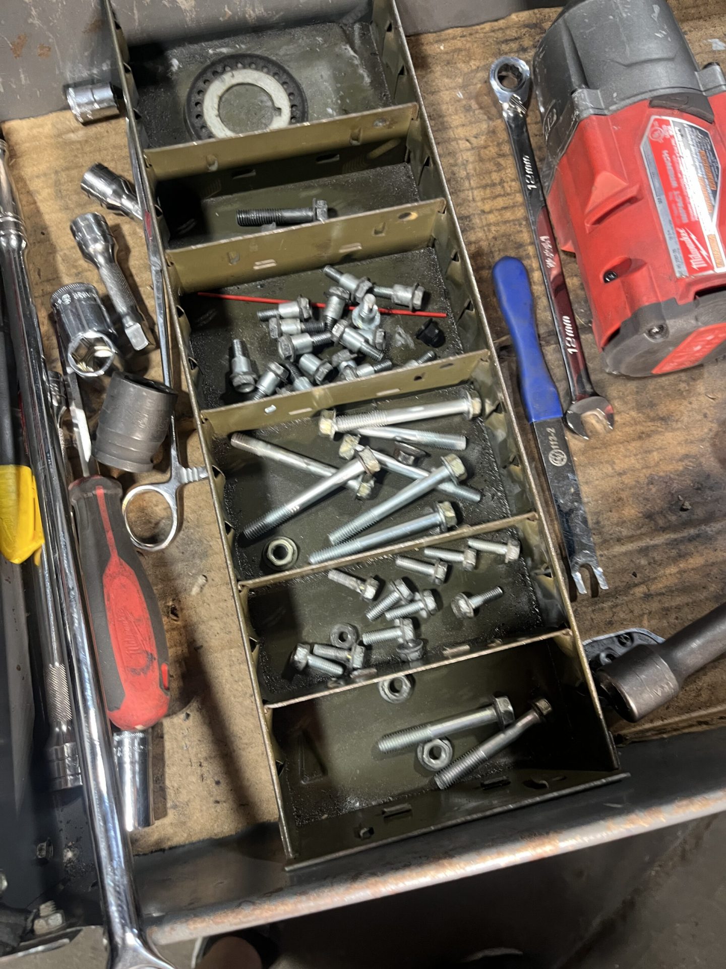 Organized engine bolts and professional Milwaukee tools during Mercedes-Benz E63 AMG engine rebuild at TOP CONCEPT Philadelphia