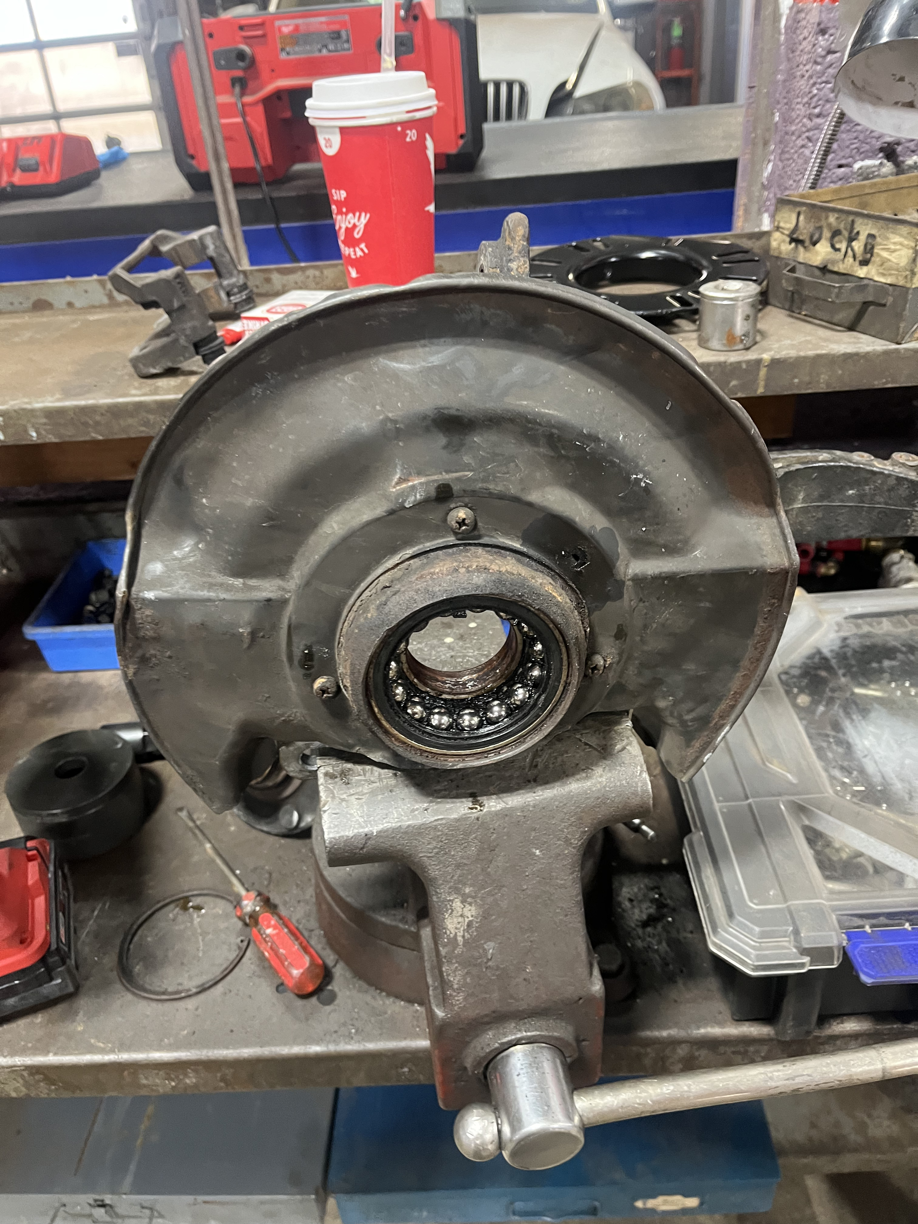 Honda Accord front knuckle on shop bench with hub bearing visible in spindle bore